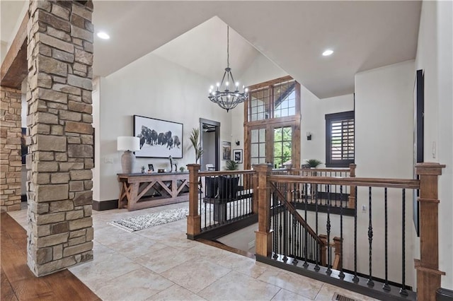11106 W 146th Ter, Overland Park, KS 66221 - dining space with a chandelier, high vaulted ceiling, decorative columns, and baseboards