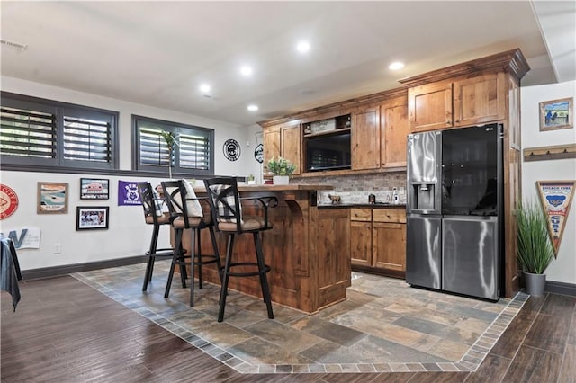 11106 W 146th Ter, Overland Park, KS 66221 - kitchen with stainless steel fridge, a breakfast bar area, backsplash, recessed lighting, and a kitchen island