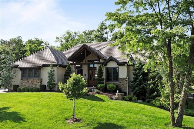 11106 W 146th Ter, Overland Park, KS 66221 - tudor home featuring stucco siding, stone siding, a front yard, and a tile roof