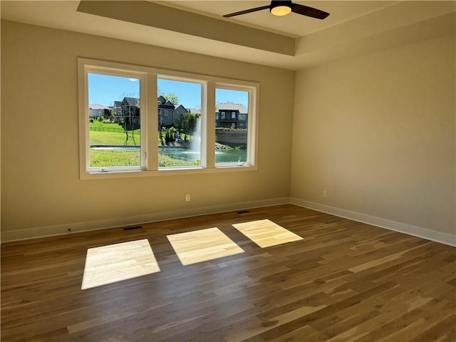 22415 87th Ter, Lenexa, KS 66227 - empty room with baseboards, wood finished floors, a raised ceiling, and ceiling fan