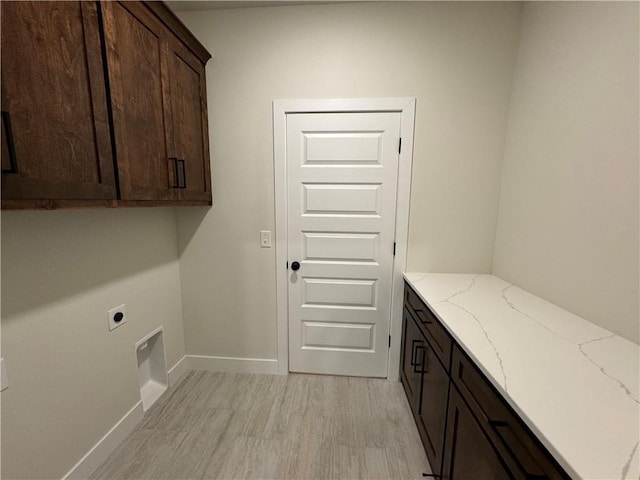 22415 87th Ter, Lenexa, KS 66227 - laundry area featuring cabinet space, electric dryer hookup, light wood-style flooring, and baseboards