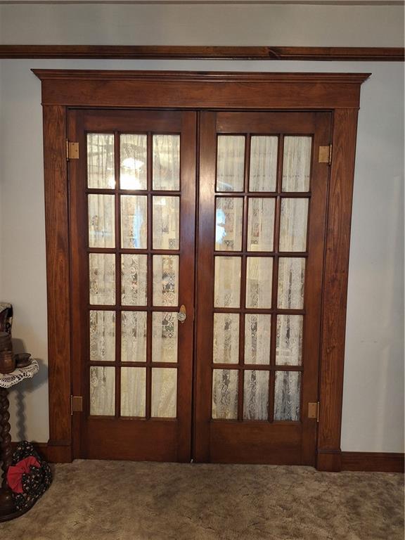 811 W Main St, Chanute, KS 66720 - doorway featuring french doors and carpet