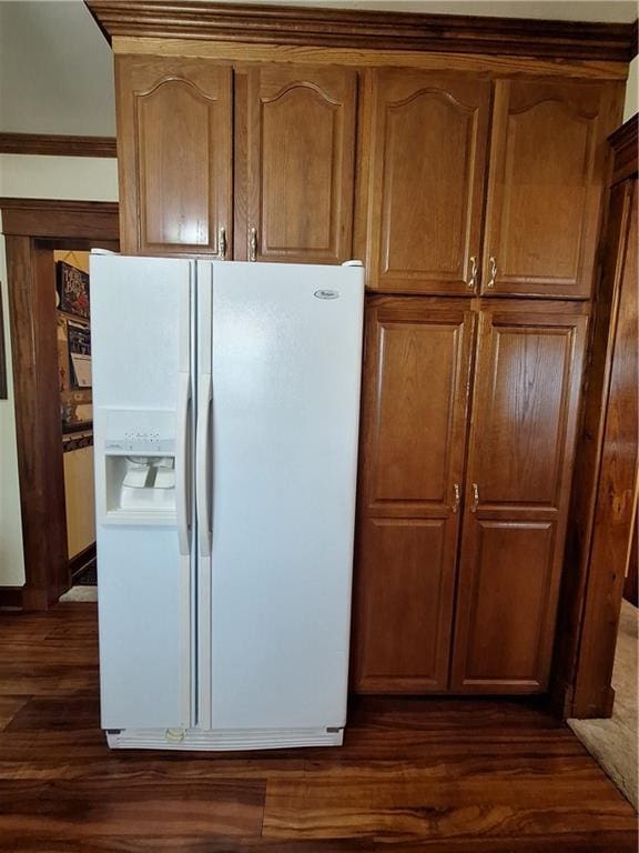 811 W Main St, Chanute, KS 66720 - kitchen with white fridge with ice dispenser, dark wood-type flooring, and brown cabinetry