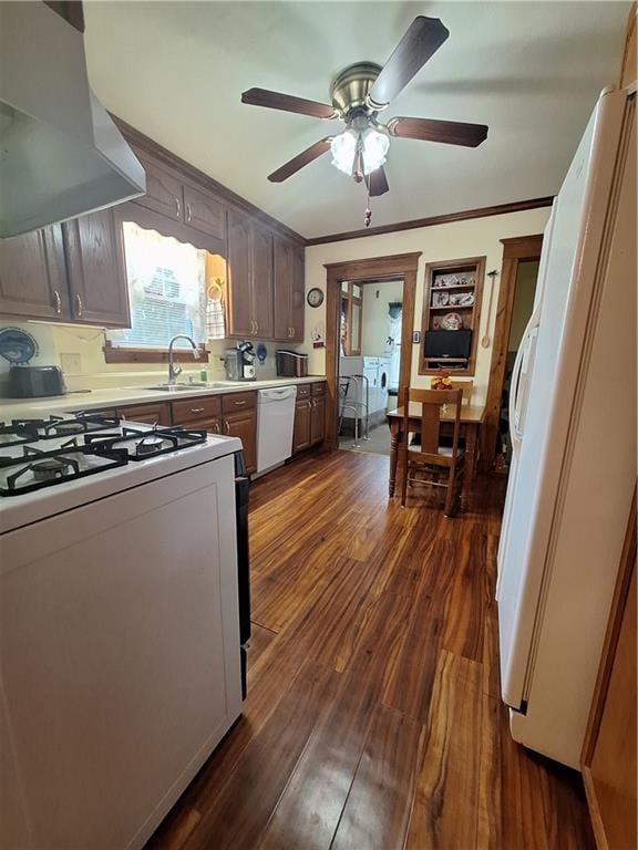 811 W Main St, Chanute, KS 66720 - kitchen with white appliances, wall chimney range hood, a sink, dark wood-style flooring, and ornamental molding