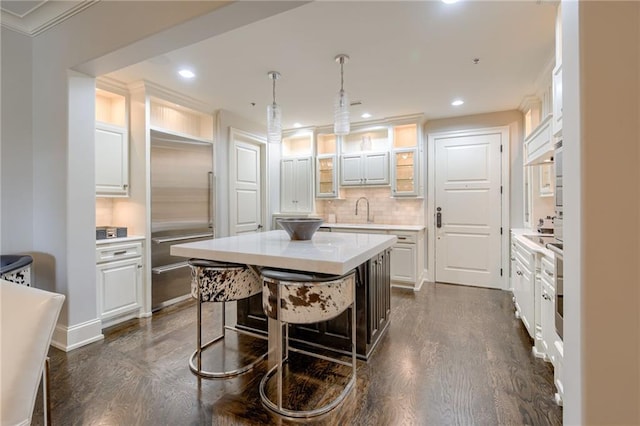 4801 W 133rd St Unit 103, Leawood, KS 66209 - kitchen featuring stainless steel built in refrigerator, light countertops, a center island, dark wood-style floors, and recessed lighting