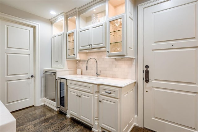 4801 W 133rd St Unit 103, Leawood, KS 66209 - bar featuring a sink, tasteful backsplash, dark wood-type flooring, wine cooler, and stainless steel dishwasher