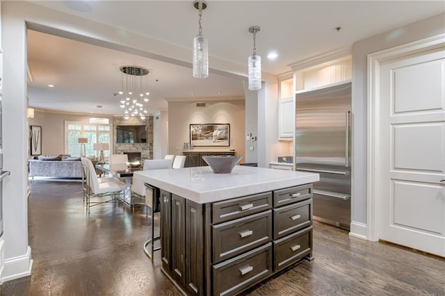 4801 W 133rd St Unit 103, Leawood, KS 66209 - kitchen with stainless steel built in fridge, decorative light fixtures, a kitchen breakfast bar, dark wood-type flooring, and recessed lighting