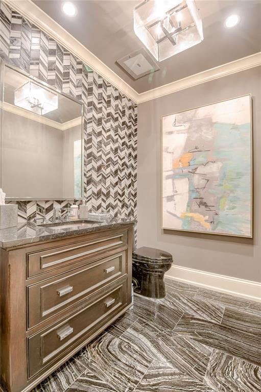 4801 W 133rd St Unit 103, Leawood, KS 66209 - half bath with ornamental molding, vanity, toilet, baseboards, and recessed lighting