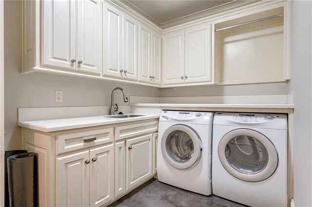 4801 W 133rd St Unit 103, Leawood, KS 66209 - washroom featuring washing machine and dryer, cabinet space, light tile patterned floors, and crown molding