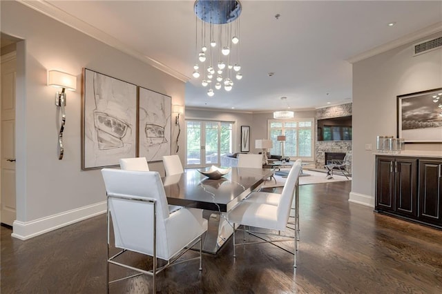 4801 W 133rd St Unit 103, Leawood, KS 66209 - dining space featuring crown molding, dark wood-type flooring, baseboards, a stone fireplace, and recessed lighting