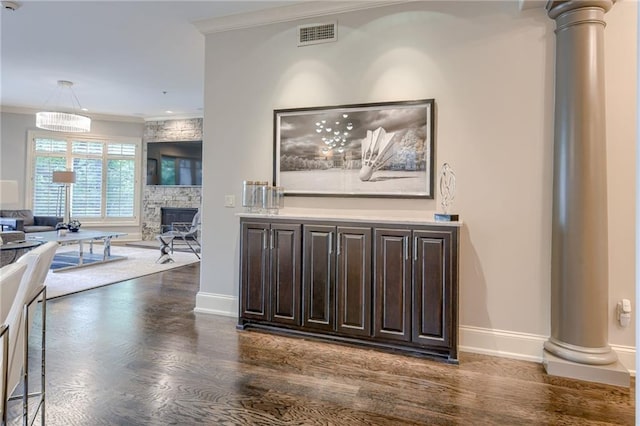 4801 W 133rd St Unit 103, Leawood, KS 66209 - living room with dark wood-type flooring, crown molding, a fireplace, baseboards, and ornate columns