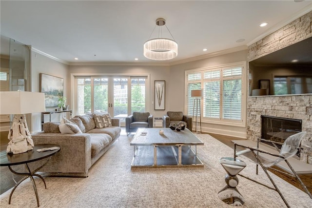 4801 W 133rd St Unit 103, Leawood, KS 66209 - living area featuring crown molding, plenty of natural light, a stone fireplace, recessed lighting, and wood finished floors