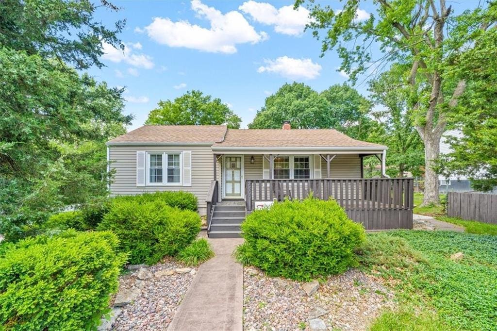 2400 NE 52nd Ter, Kansas City, MO 64118 - view of front of home with covered porch and a chimney