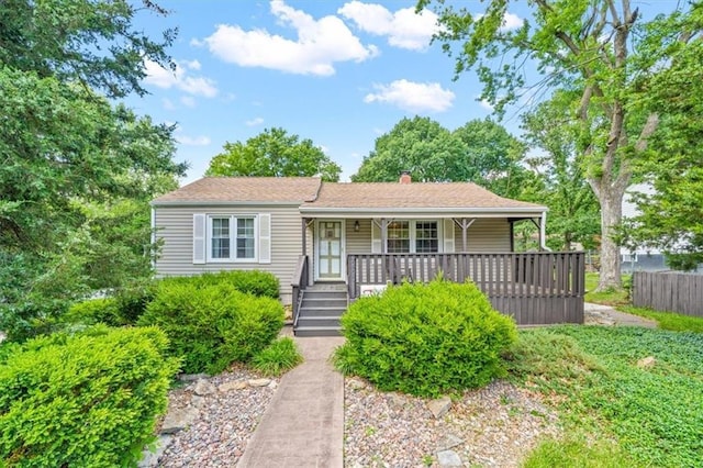 2400 NE 52nd Ter, Kansas City, MO 64118 - view of front of home with covered porch and a chimney