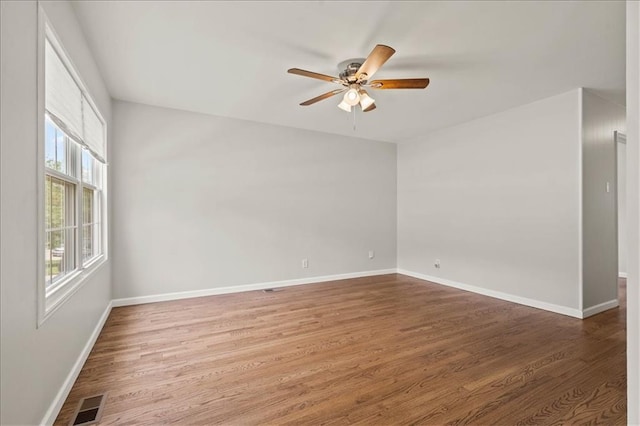 307 E 3rd Dr S, Independence, MO 64050 - spare room featuring a ceiling fan, wood finished floors, and baseboards