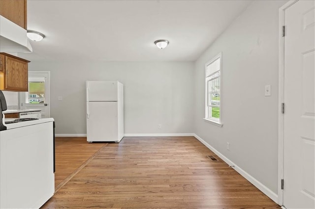 307 E 3rd Dr S, Independence, MO 64050 - kitchen with white appliances, light wood-type flooring, baseboards, and brown cabinets