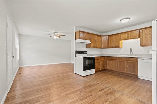 307 E 3rd Dr S, Independence, MO 64050 - kitchen with white appliances, a sink, under cabinet range hood, a ceiling fan, and light countertops