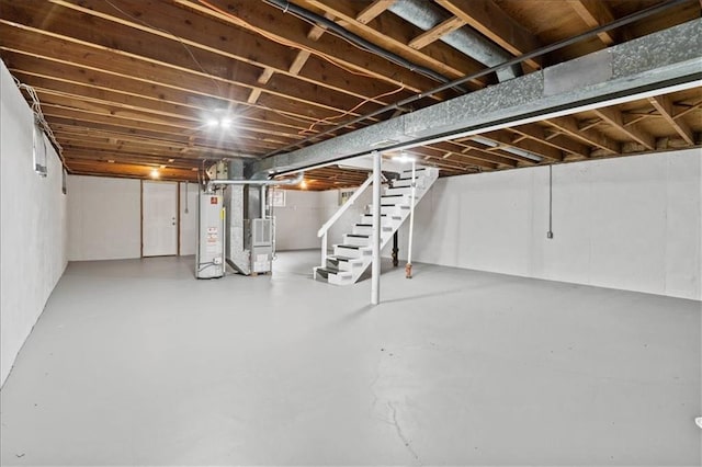 307 E 3rd Dr S, Independence, MO 64050 - unfinished basement with stairs, water heater, and heating unit