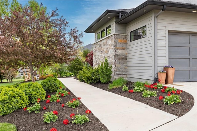 25075 W 105th Ter, Olathe, KS 66061 - view of home's exterior featuring stone siding and a garage