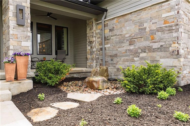 25075 W 105th Ter, Olathe, KS 66061 - view of exterior entry with a porch, stone siding, and a ceiling fan