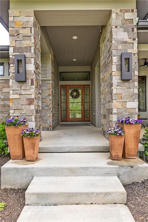 25075 W 105th Ter, Olathe, KS 66061 - doorway to property with stone siding and a porch