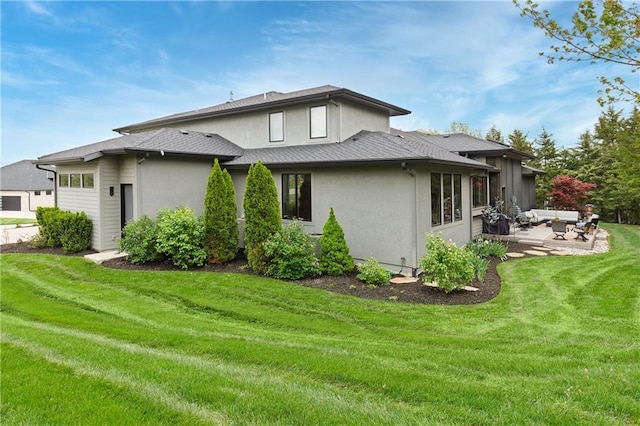 25075 W 105th Ter, Olathe, KS 66061 - back of house featuring an outdoor hangout area, stucco siding, a patio, a yard, and a garage
