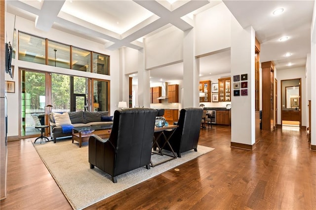 25075 W 105th Ter, Olathe, KS 66061 - living room featuring dark wood-style floors, a high ceiling, recessed lighting, coffered ceiling, and beamed ceiling