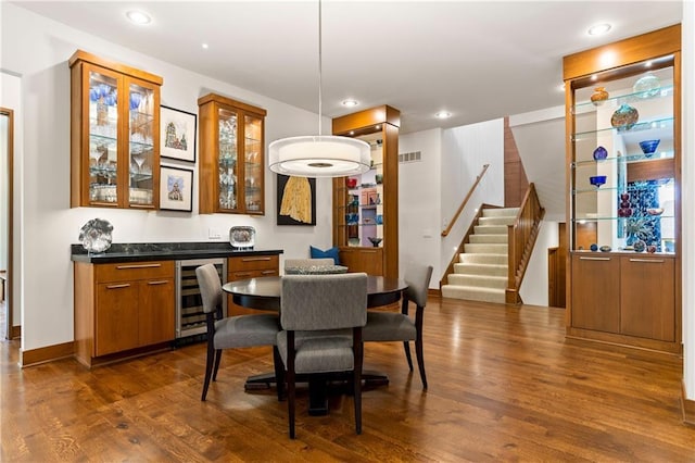 25075 W 105th Ter, Olathe, KS 66061 - dining room featuring wine cooler, bar, stairs, dark wood finished floors, and recessed lighting