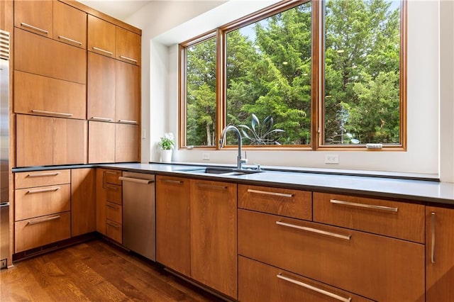 25075 W 105th Ter, Olathe, KS 66061 - kitchen with stainless steel dishwasher, dark wood-style flooring, plenty of natural light, and brown cabinetry
