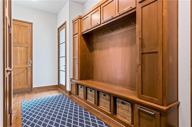 25075 W 105th Ter, Olathe, KS 66061 - mudroom with dark wood finished floors and baseboards