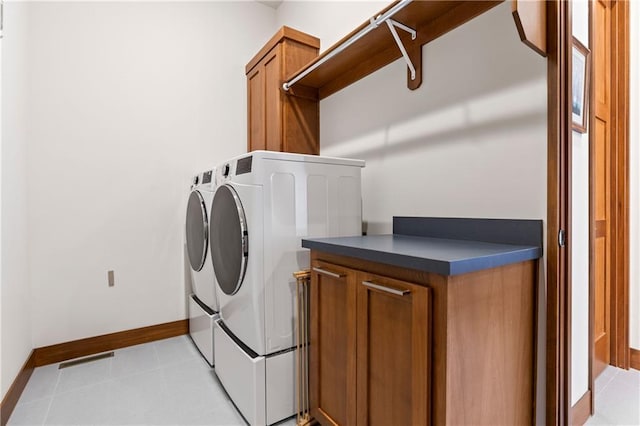25075 W 105th Ter, Olathe, KS 66061 - laundry area featuring independent washer and dryer, cabinet space, and light tile patterned floors