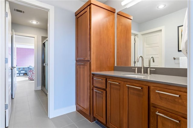 25075 W 105th Ter, Olathe, KS 66061 - bathroom featuring vanity, tile patterned flooring, and a shower with shower door