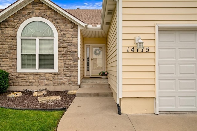 14175 W 155th St, Olathe, KS 66062 - entrance to property featuring stone siding, an attached garage, and a shingled roof