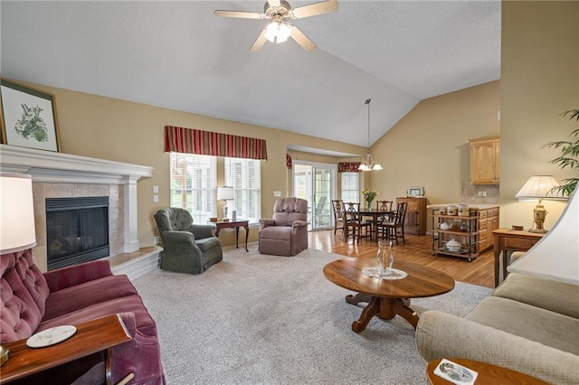 14175 W 155th St, Olathe, KS 66062 - living room featuring high vaulted ceiling, ceiling fan, a tile fireplace, a chandelier, and carpet floors