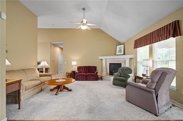 14175 W 155th St, Olathe, KS 66062 - carpeted living area featuring a ceiling fan, healthy amount of natural light, a tiled fireplace, and lofted ceiling