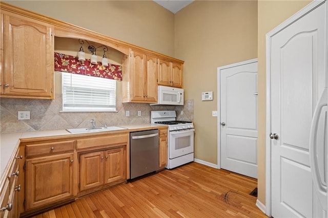 14175 W 155th St, Olathe, KS 66062 - kitchen featuring white appliances, a sink, tasteful backsplash, light countertops, and a high ceiling