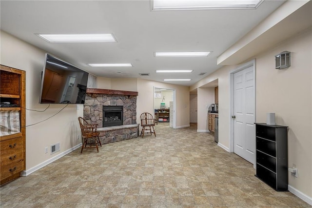 14175 W 155th St, Olathe, KS 66062 - living room featuring a stone fireplace and baseboards