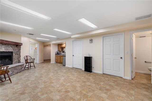 14175 W 155th St, Olathe, KS 66062 - living area featuring a stone fireplace, baseboards, and stone finish flooring