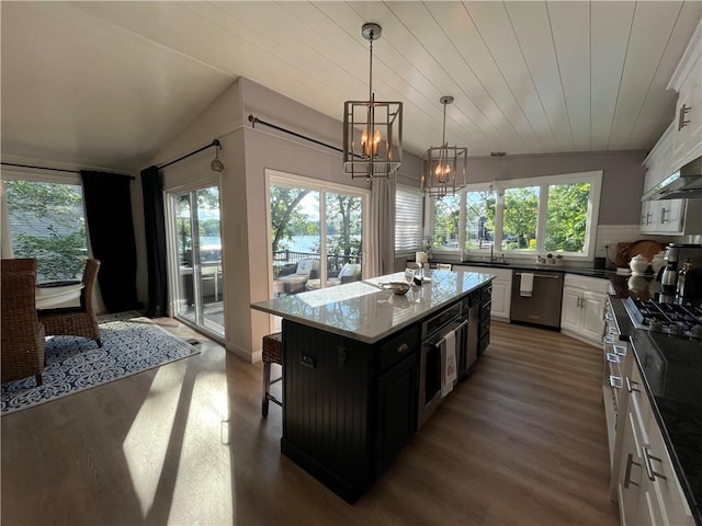 53 Z St, Lees Summit, MO 64086 - kitchen with dishwasher, a chandelier, healthy amount of natural light, white cabinetry, and vaulted ceiling