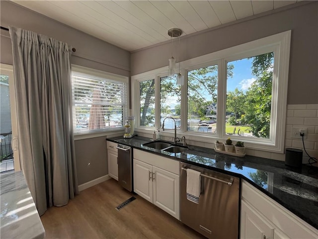 53 Z St, Lees Summit, MO 64086 - kitchen with stainless steel dishwasher, a sink, light wood finished floors, white cabinets, and dark stone countertops