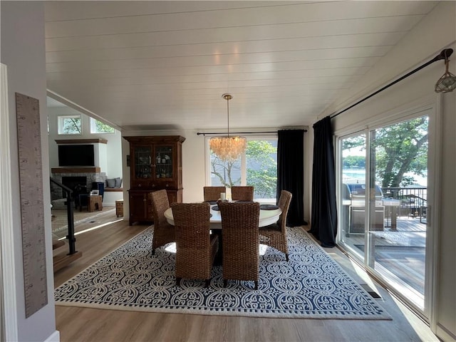 53 Z St, Lees Summit, MO 64086 - dining room featuring healthy amount of natural light, light wood finished floors, and a fireplace