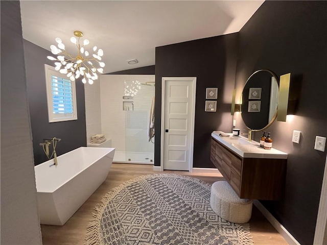 53 Z St, Lees Summit, MO 64086 - full bath with lofted ceiling, wood finished floors, vanity, a freestanding bath, and a chandelier