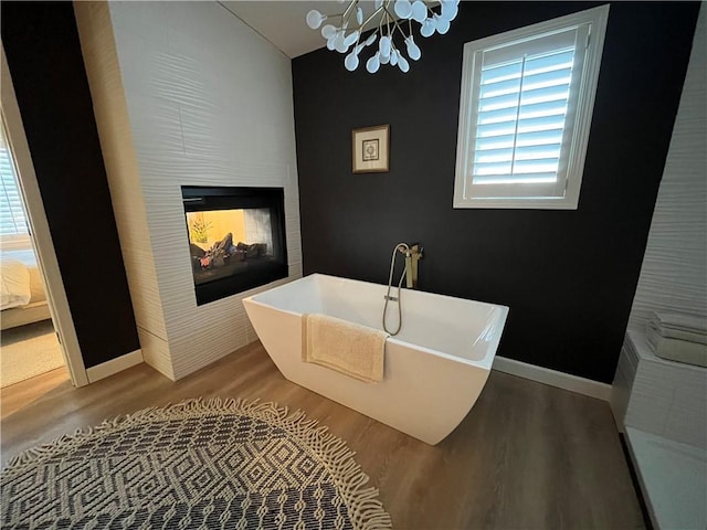 53 Z St, Lees Summit, MO 64086 - bathroom with wood finished floors, a chandelier, a freestanding tub, and baseboards