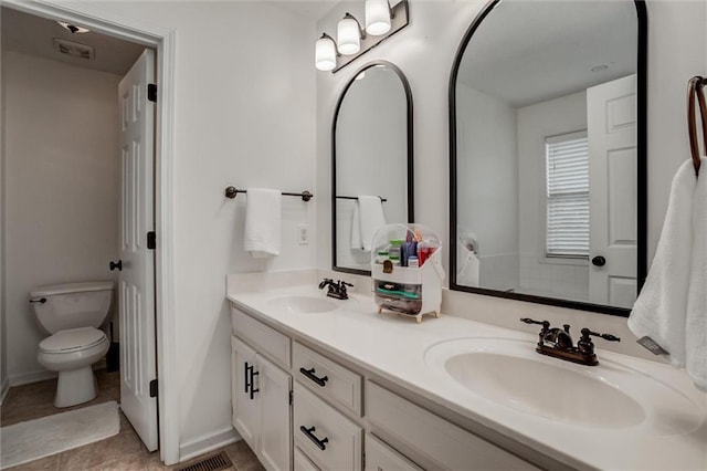 706 S Sunset Ln, Raymore, MO 64083 - bathroom featuring double vanity, toilet, and tile patterned flooring