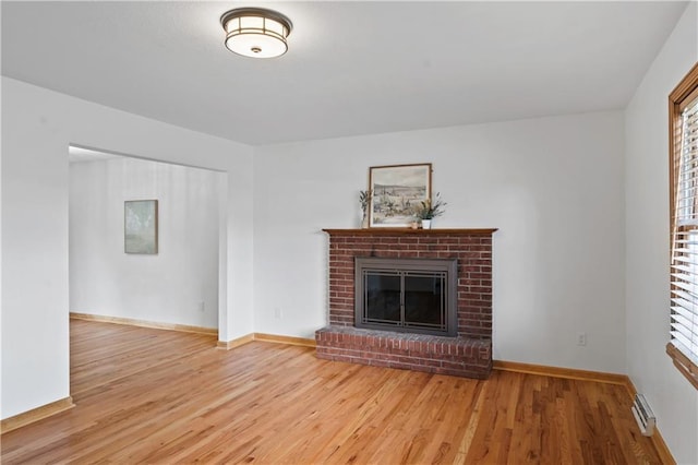 4417 E 104th St, Kansas City, MO 64137 - unfurnished living room featuring wood finished floors, a fireplace, and baseboards