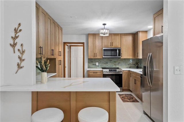 4417 E 104th St, Kansas City, MO 64137 - kitchen featuring appliances with stainless steel finishes, a peninsula, light countertops, and tasteful backsplash