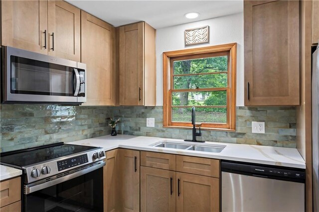 4417 E 104th St, Kansas City, MO 64137 - kitchen with appliances with stainless steel finishes, a sink, decorative backsplash, and light stone countertops