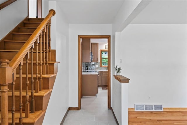 4417 E 104th St, Kansas City, MO 64137 - staircase with baseboards