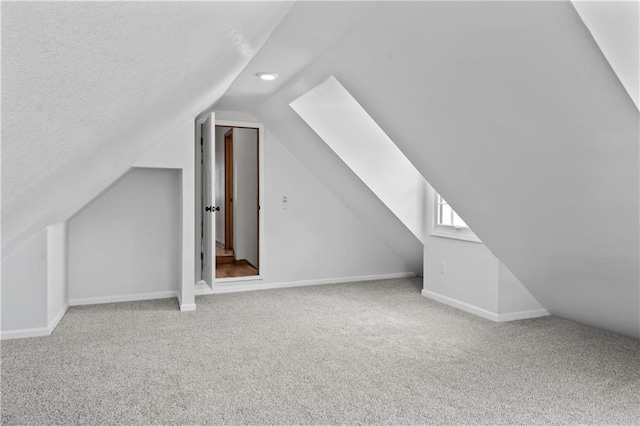 4417 E 104th St, Kansas City, MO 64137 - additional living space featuring carpet, lofted ceiling, baseboards, recessed lighting, and a textured ceiling