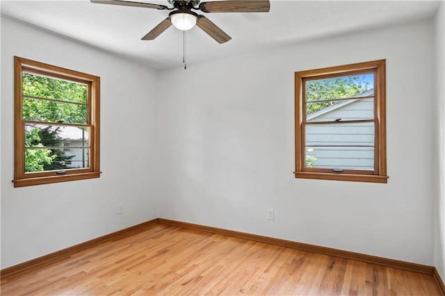 4417 E 104th St, Kansas City, MO 64137 - unfurnished room with baseboards, light wood-style flooring, and ceiling fan